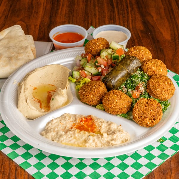 Leyla's Mediterranean Cafe falafel platter with hummus, baba ghanoush, salad, and pita bread.