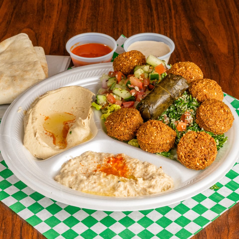Leyla's Mediterranean Cafe falafel platter with hummus, baba ghanoush, salad, and pita bread.