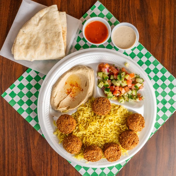 Leyla's Mediterranean Cafe falafel platter with rice, hummus, salad, pita, and sauces.