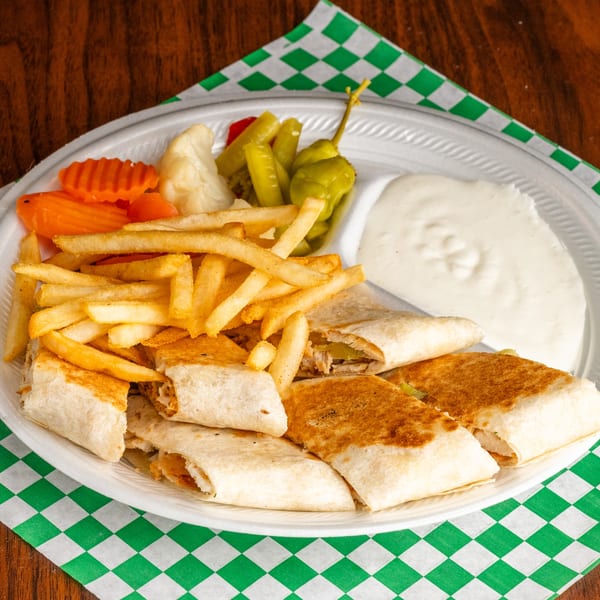 Leyla's Mediterranean Cafe shawarma wraps with fries, pickled vegetables, and white dipping sauce on a plate.